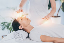 Female receiving a Reiki treatment from a Reiki Master in a spa setting.